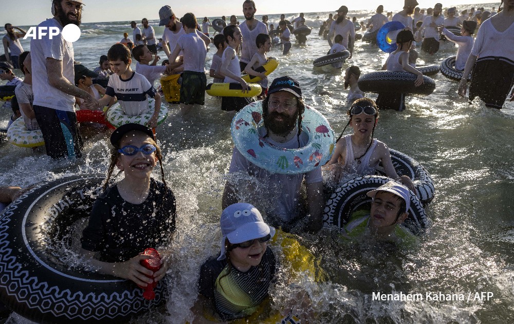 Ultra-Orthodox Jews swim at a beach reserved for men only